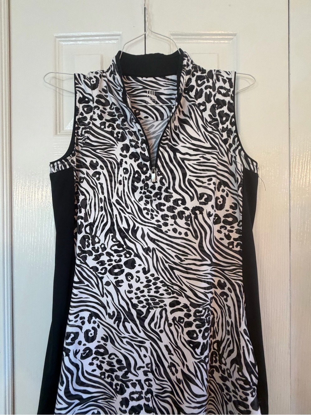TAIL-Sleeveless Black & White Animal Print Golf Dress with ruffle bottom.